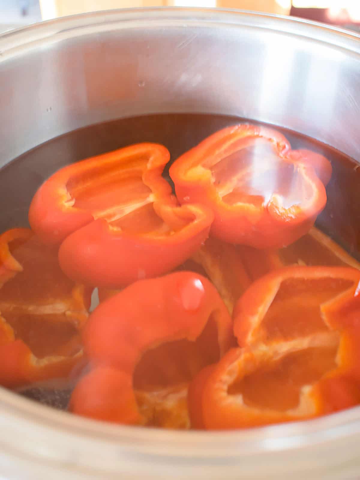 red pepper halves in pot of water 