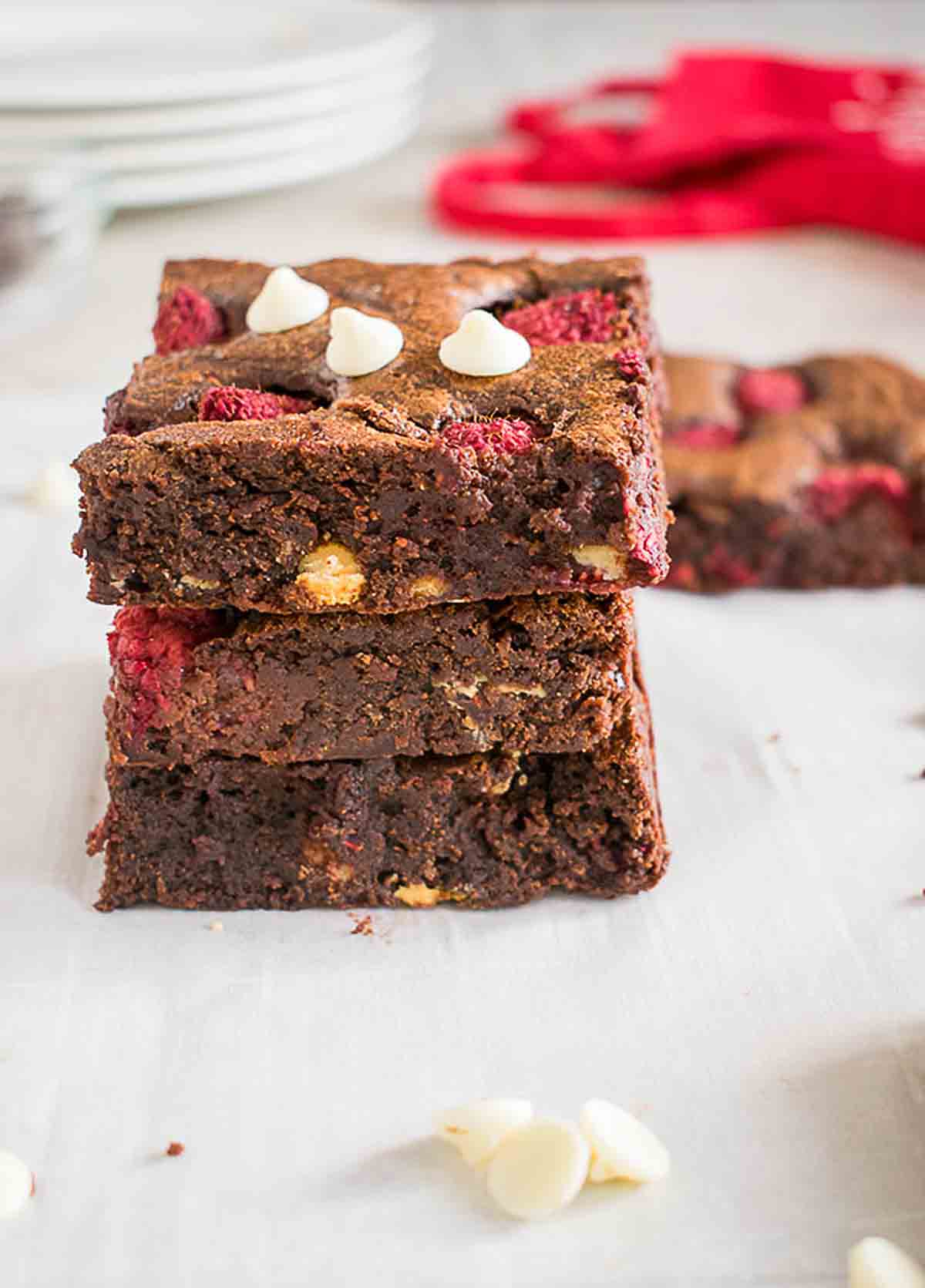 stack of three raspberry brownies with white chocolate chips