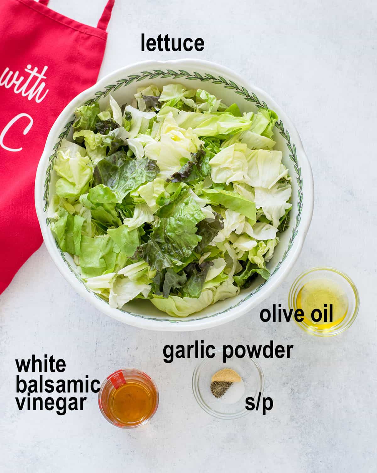 bowl of lettuce, portions of oil, vinegar, seasonings