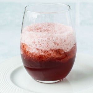 red wine slushie in glass on white plate