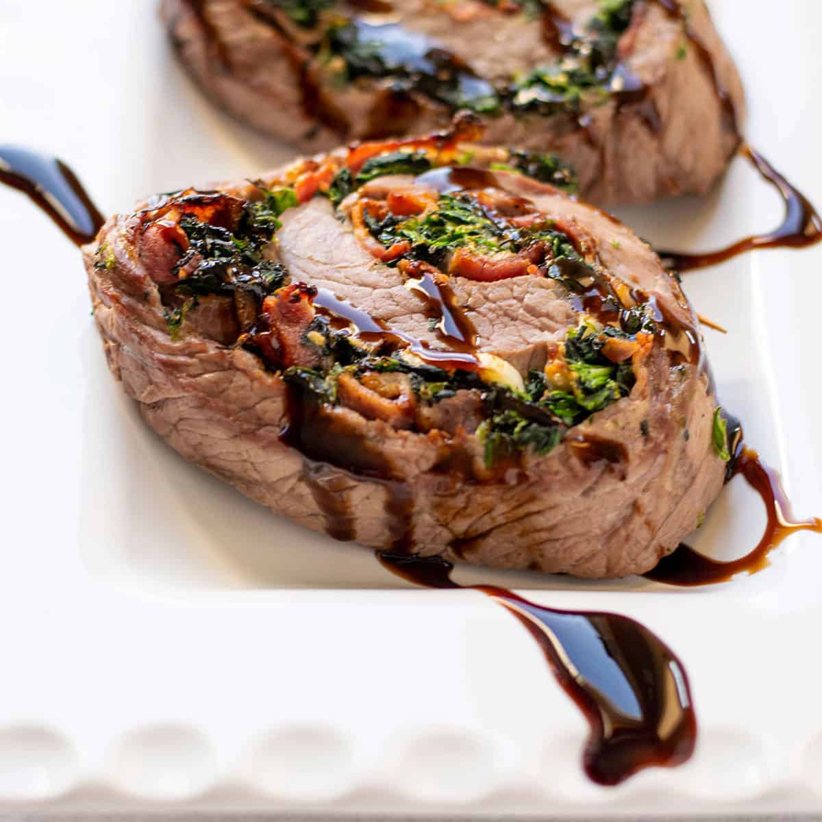 steak pinwheel with bacon, spinach and balsamic glaze.