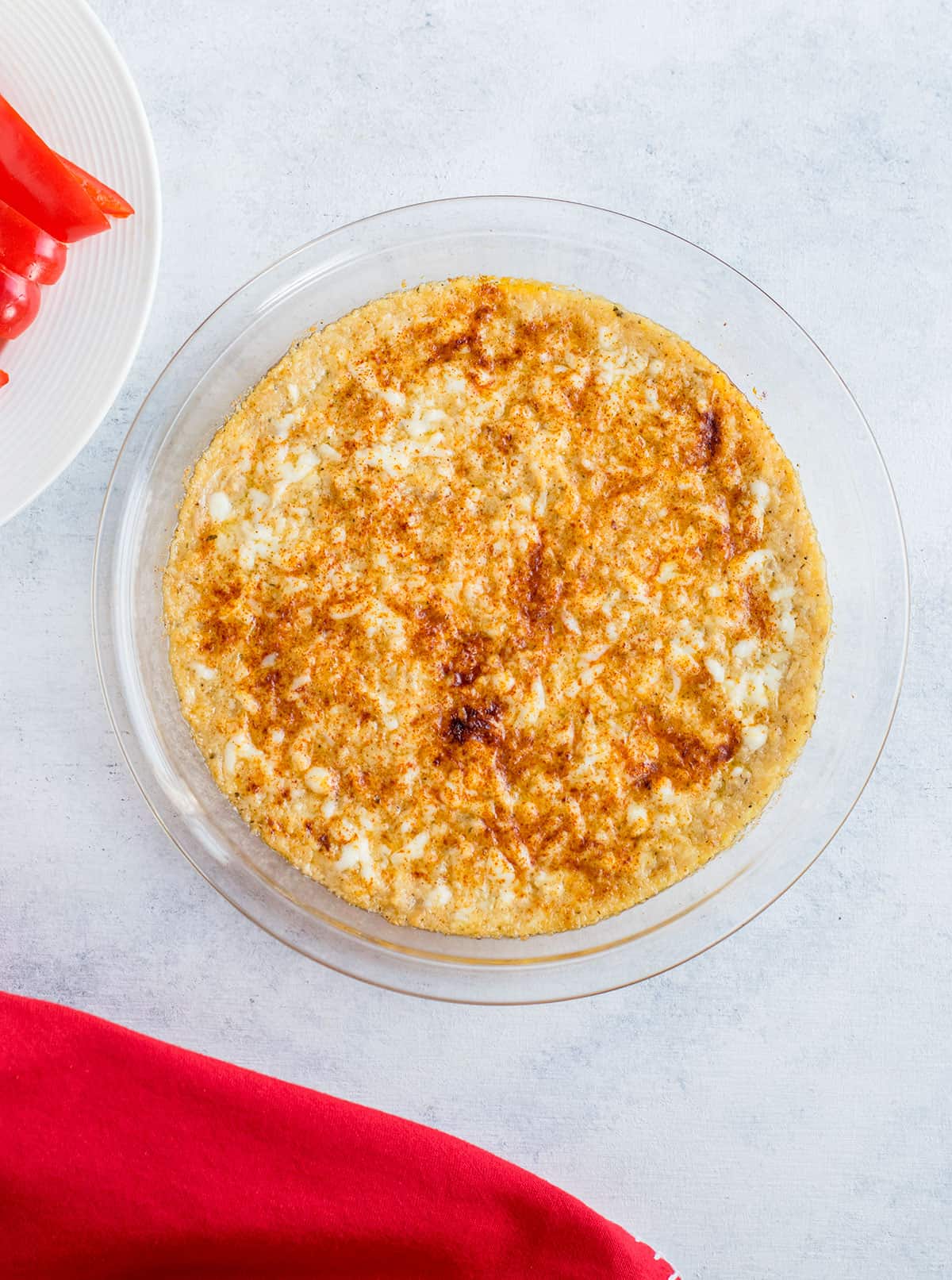 baked dip with red pepper strips on the side