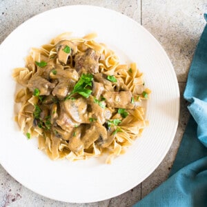 beef Stroganoff with mushrooms and noodles on plate