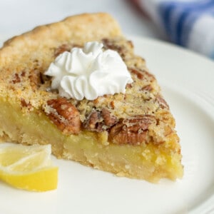 slice of lemon pie with pecans and whipped cream