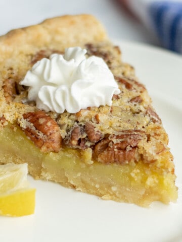 slice of lemon pie with pecans and whipped cream