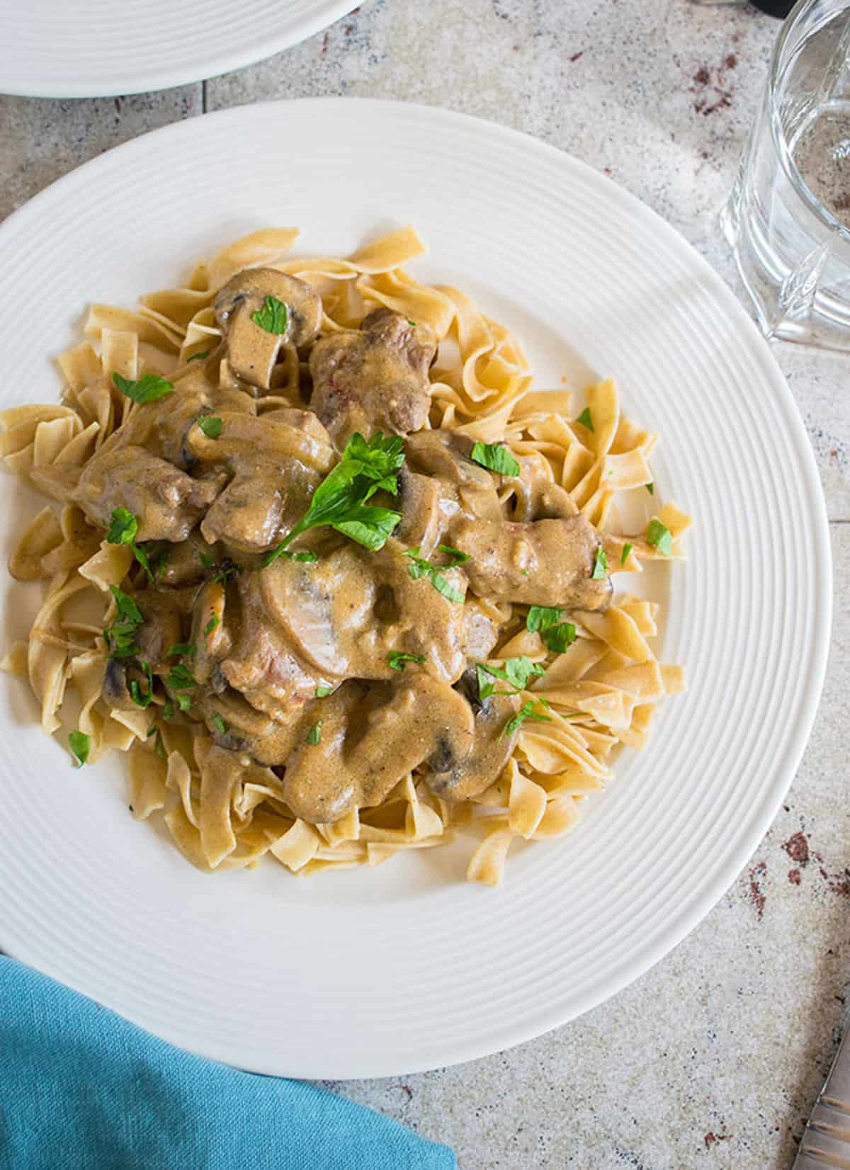 beef Stroganoff with mushrooms and noodles on plate