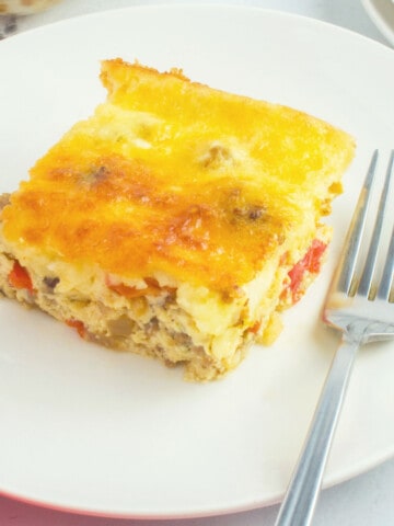 portion of sausage and egg bake on plate with fork