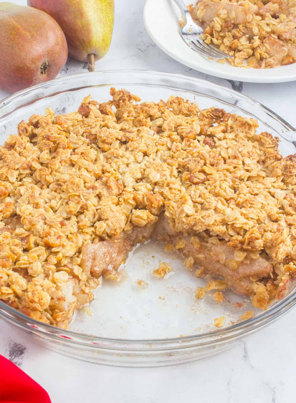 pie dish of pear crisp with a couple of pieces missing