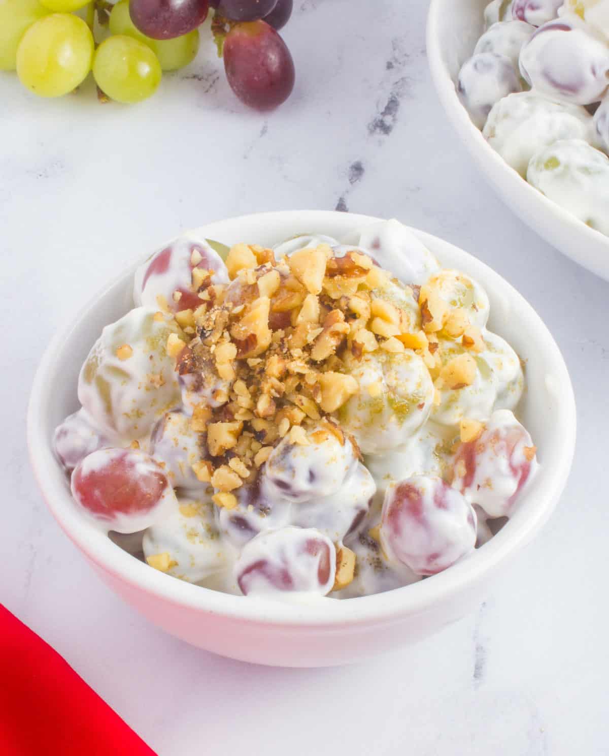 bowl of creamy grape salad with walnuts
