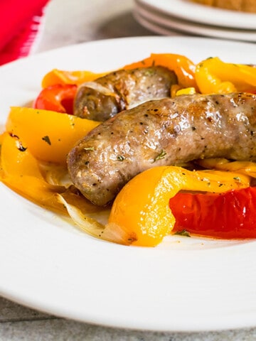 plate of sausage, peppers and onions