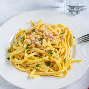 Fettuccine Carbonara on white plate with fork