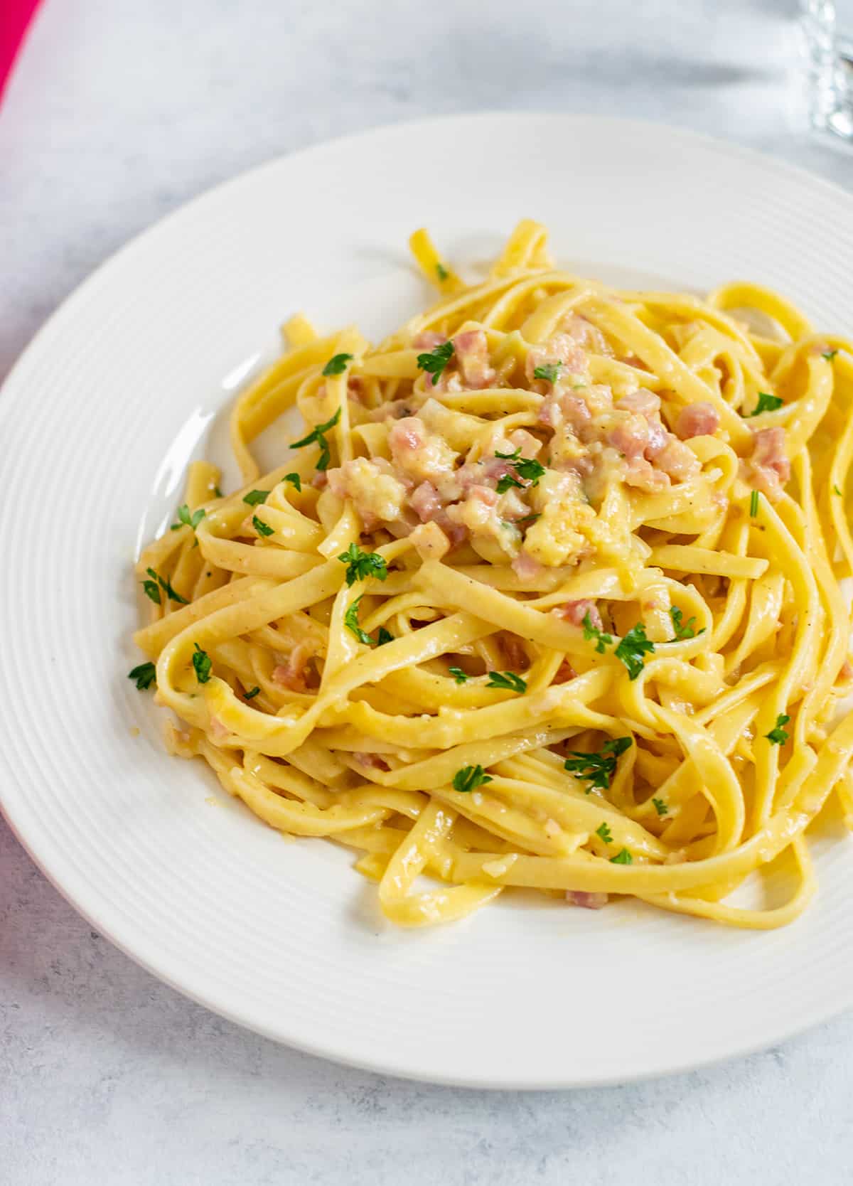 plate of fettuccine carbonara with parsley