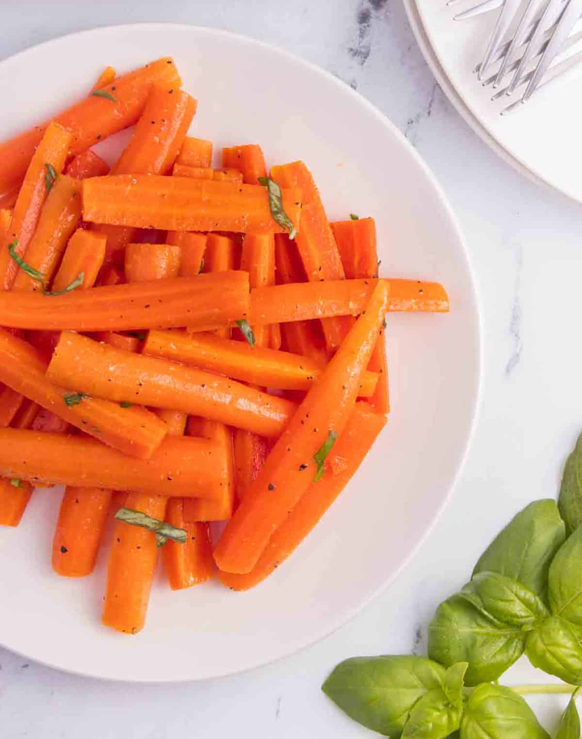 carrot salad on plate with basil