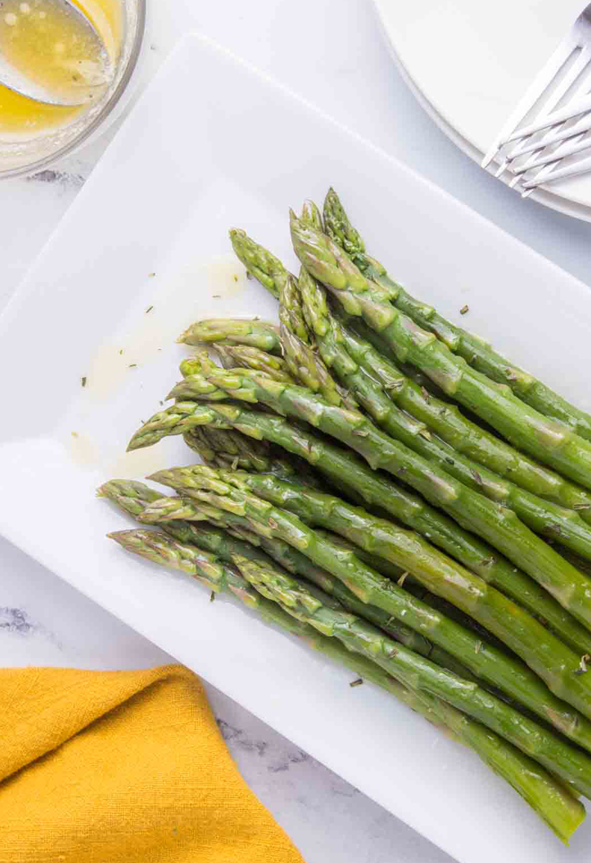 cooked asparagus with melted butter, gold napkin