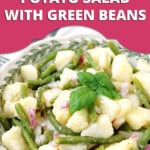 Pin Image for Italian Potato Salad with Green Beans by Cooking with Mamma C. Prepared potato salad with green beans in a bowl with basil on top.