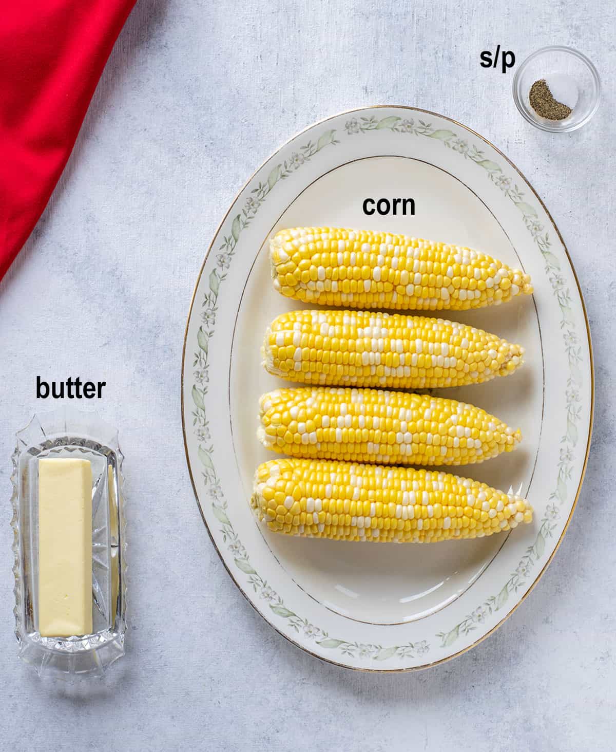 stick of butter, raw corn on the cob, salt and pepper
