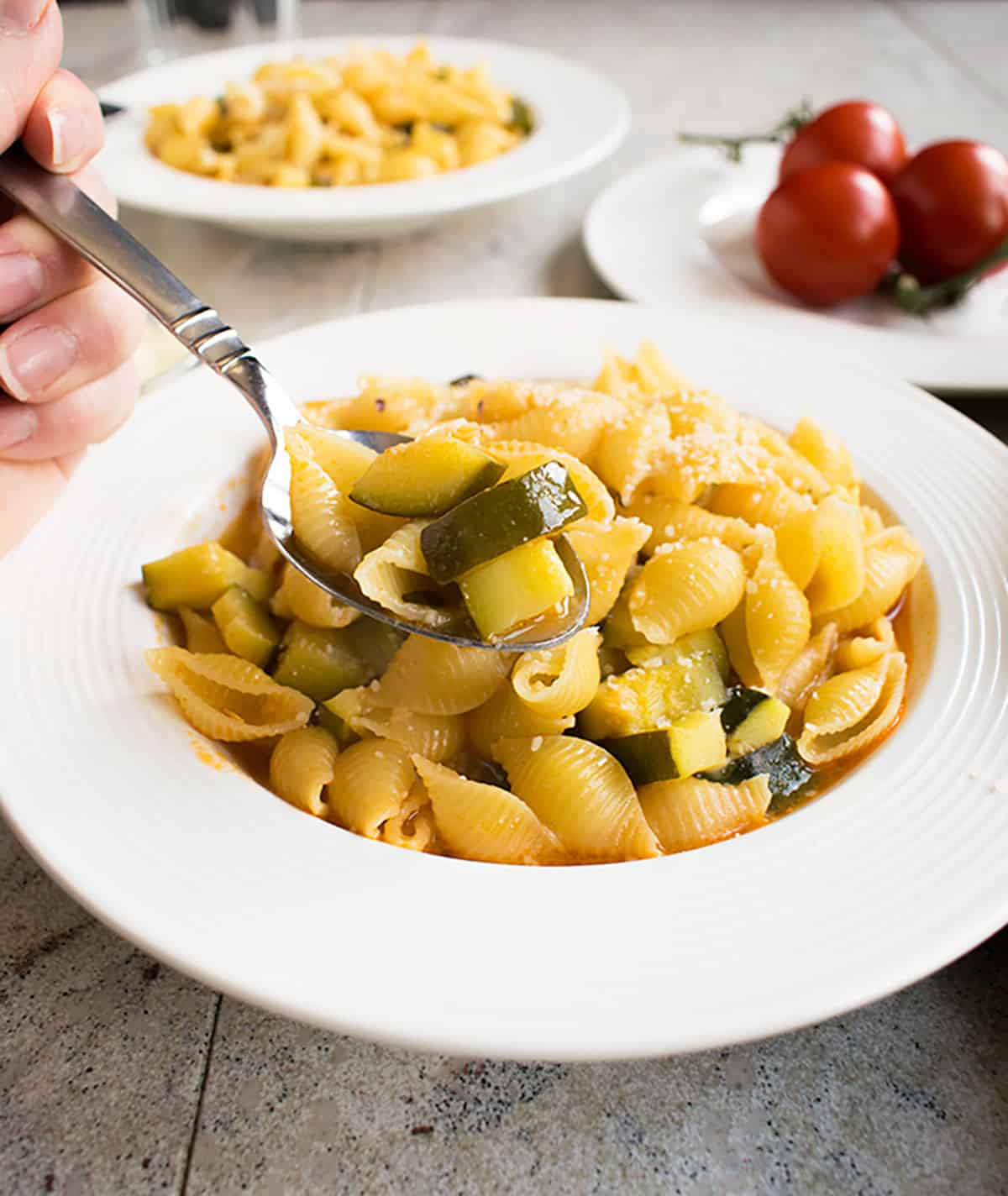 prepared pasta with zucchini in a soup dish