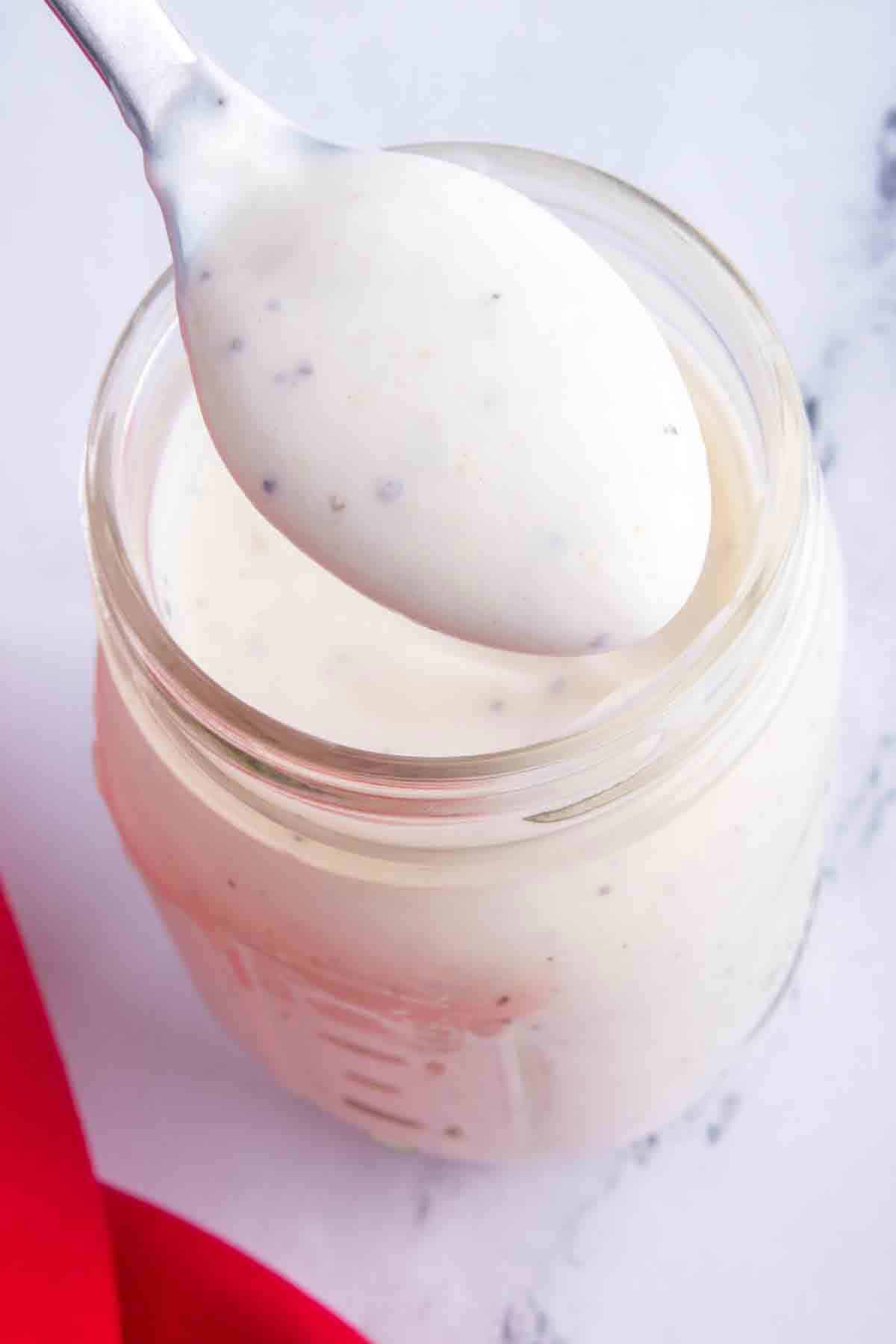 spoonful of ranch dressing from a mason jar