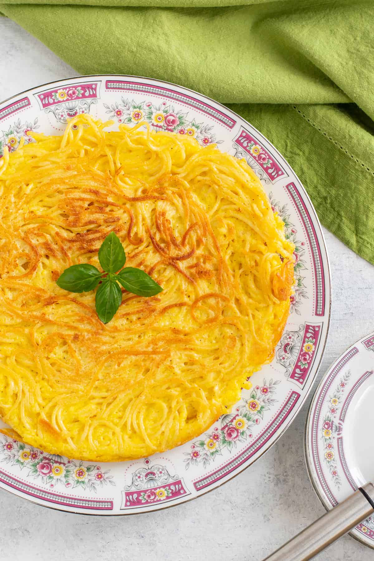 prepared spaghetti frittata garnished with basil
