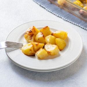 roasted potatoes on a plate with a fork