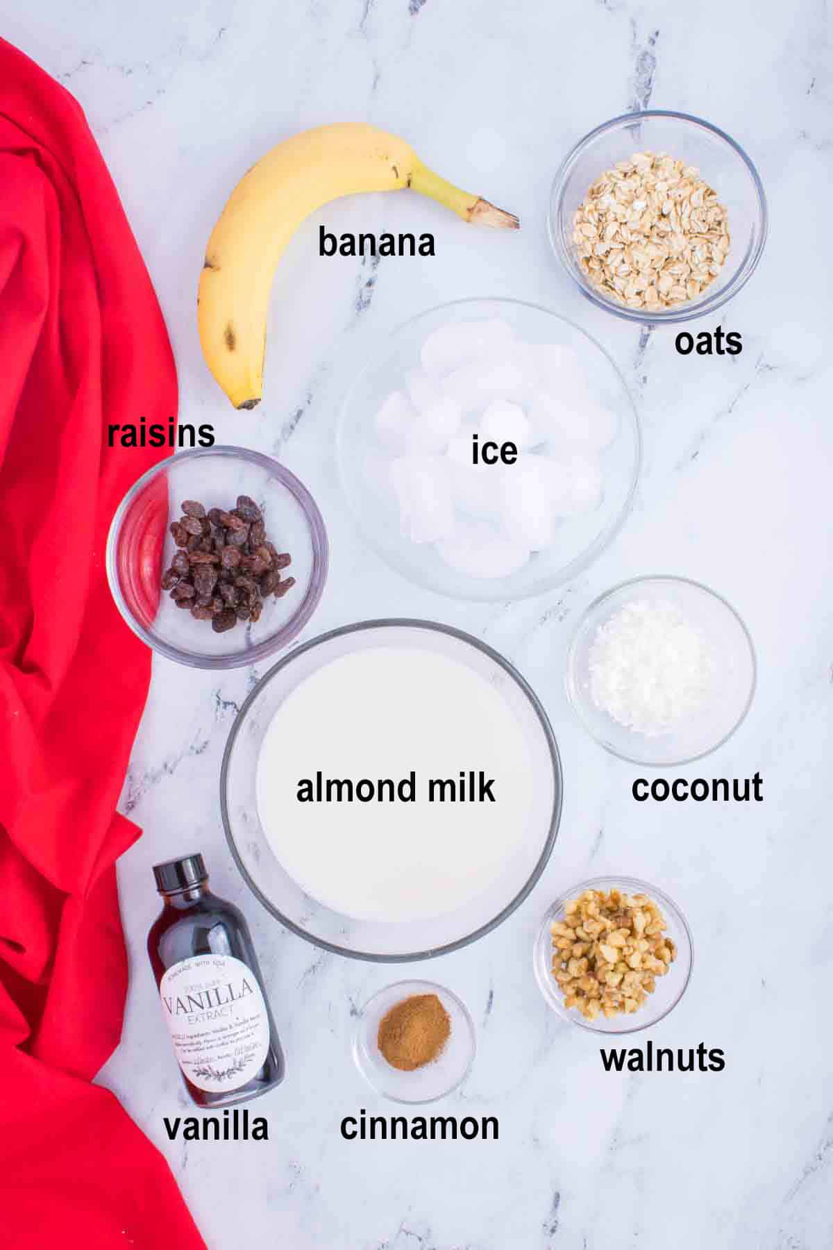 banana, oats, raisins, ice, almond milk, coconut, vanilla, cinnamon, walnuts.