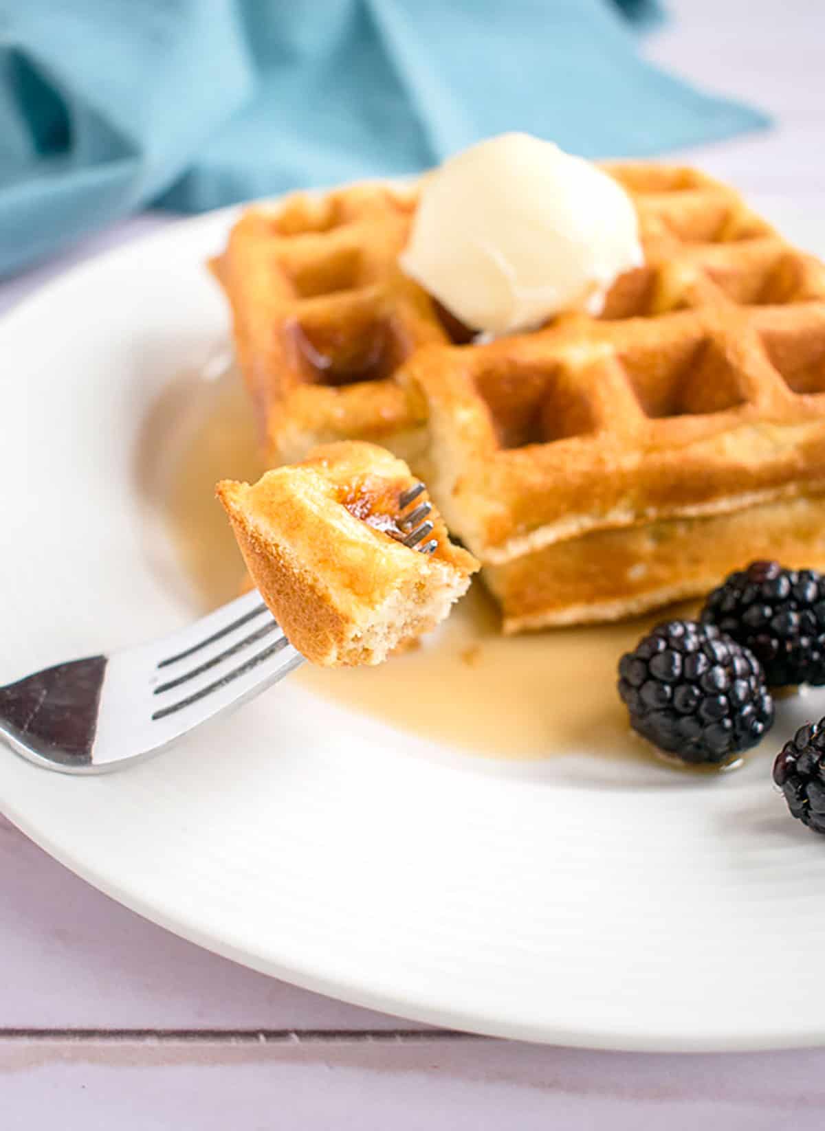 fork holding up a piece of homemade waffle