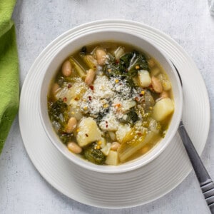 prepared escarole soup with beans and potatoes in a bowl