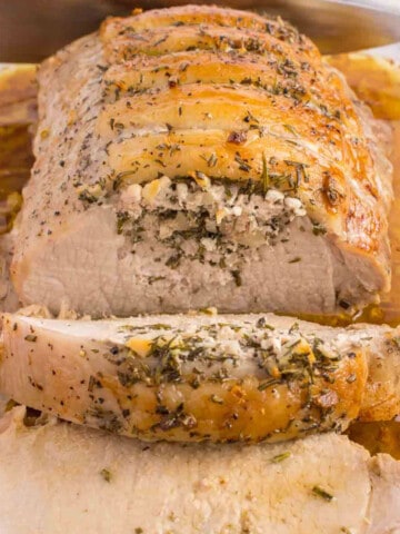 roasted pork loin in pan partially sliced