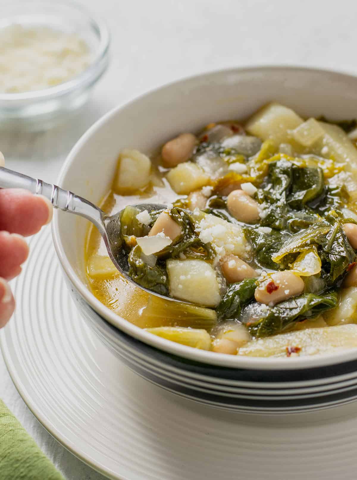 prepared escarole soup with beans and potatoes in a bowl