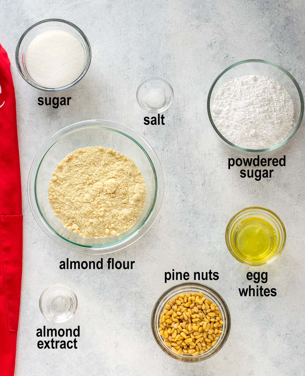 sugar, salt, powdered sugar, almond flour, egg whites, almond extract, pine nuts