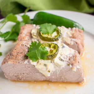 pork tenderloin stuffed with cream cheese and jalapeño garnished with cilantro