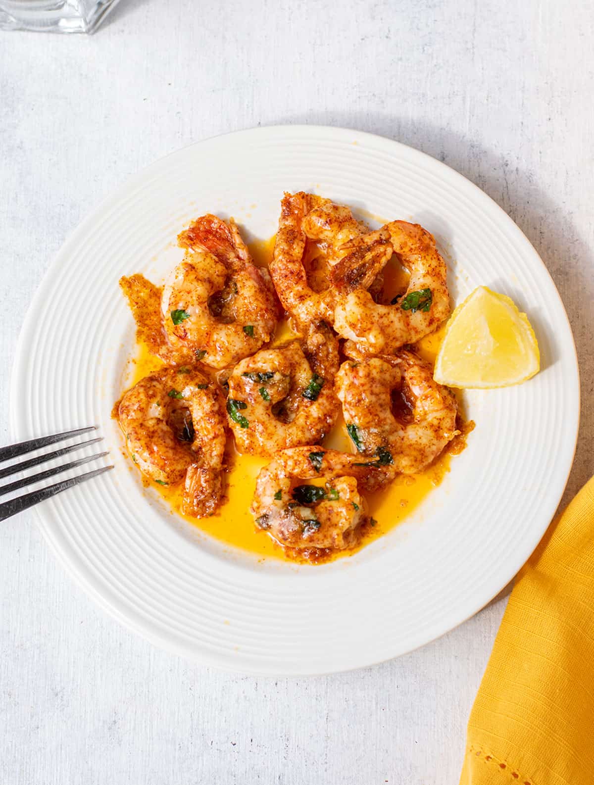 plate of garlic parmesan shrimp with butter sauce