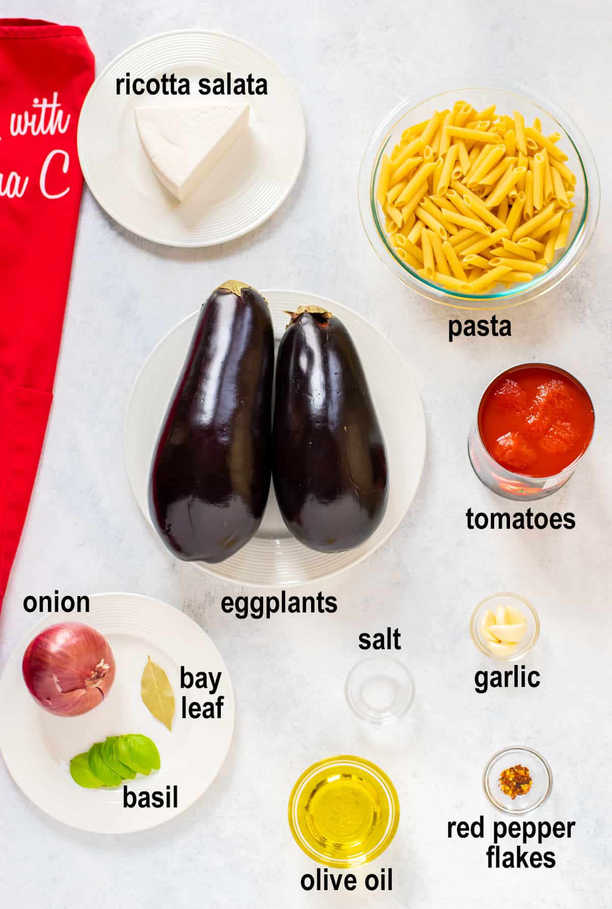 ricotta salata, pasta, eggplants, tomatoes, onion, bay leaf, basil, oil, garlic, salt, pepper.