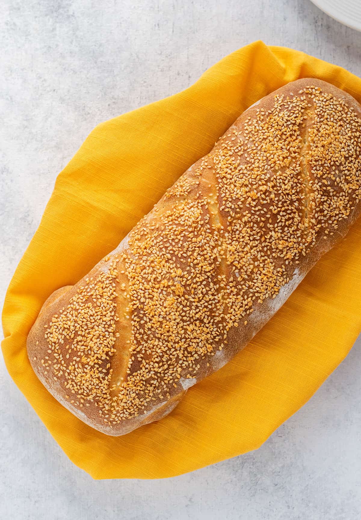 loaf of italian bread topped with sesame seeds