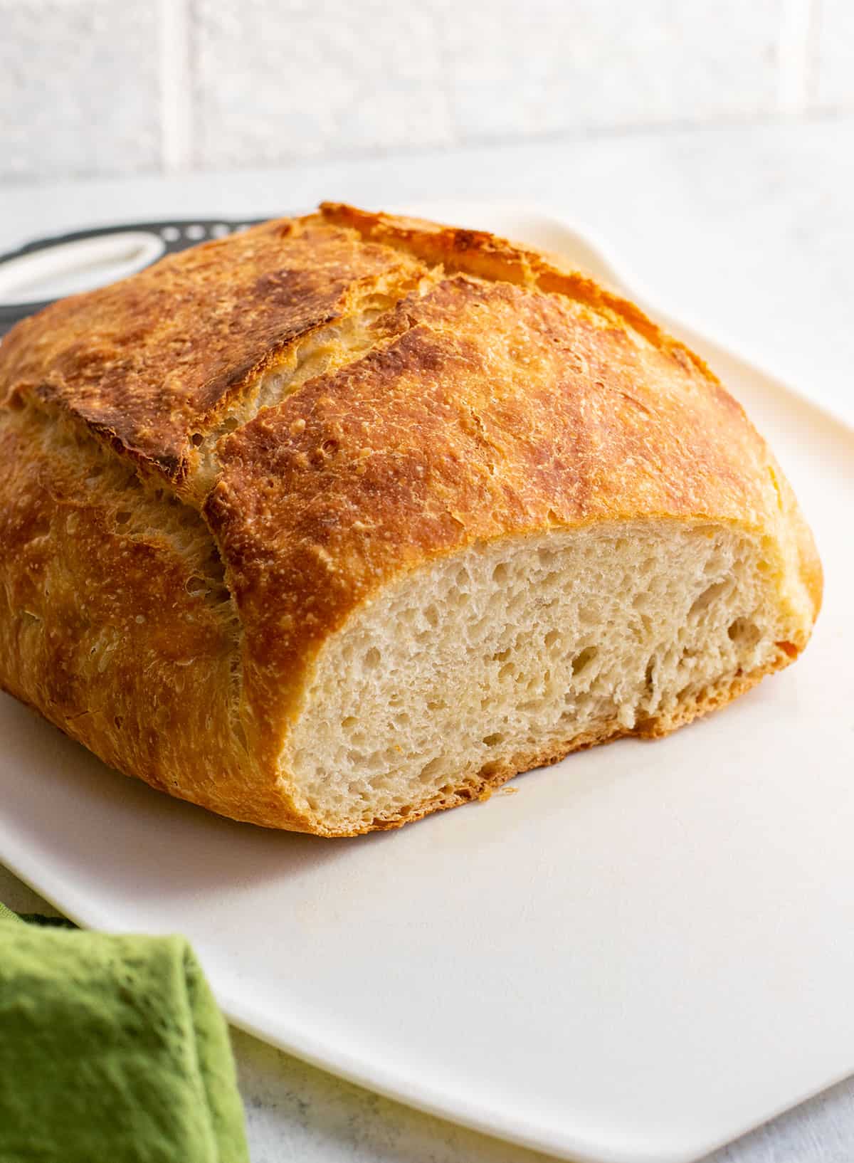 loaf of crusty italian bread sliced open on a cutting board