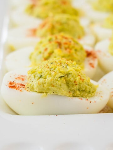 close-up photo of pesto deviled eggs on a platter