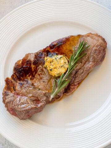 steak with compound butter and fresh rosemary