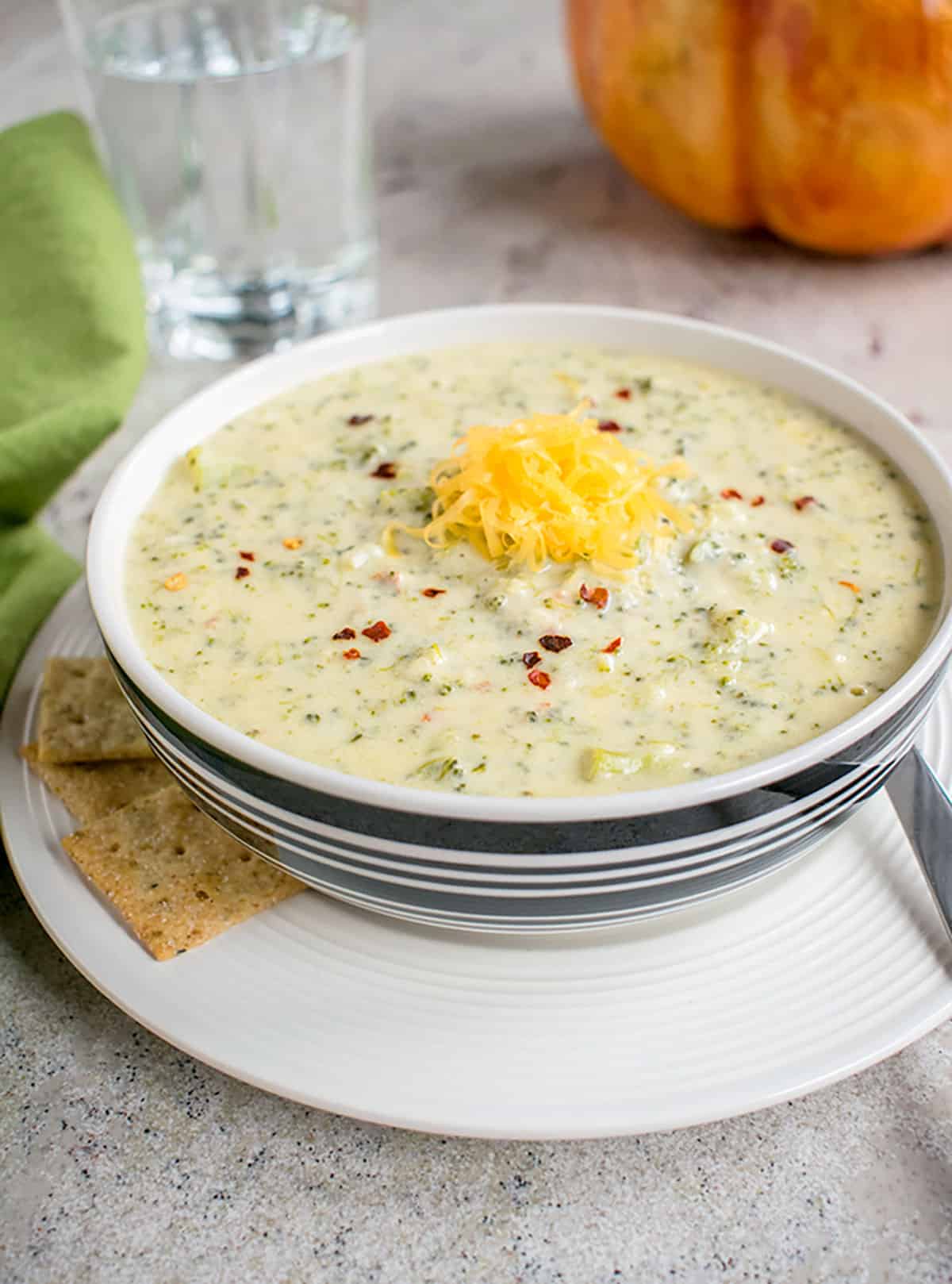 bowl of broccoli cheddar soup topped with cheddar cheese