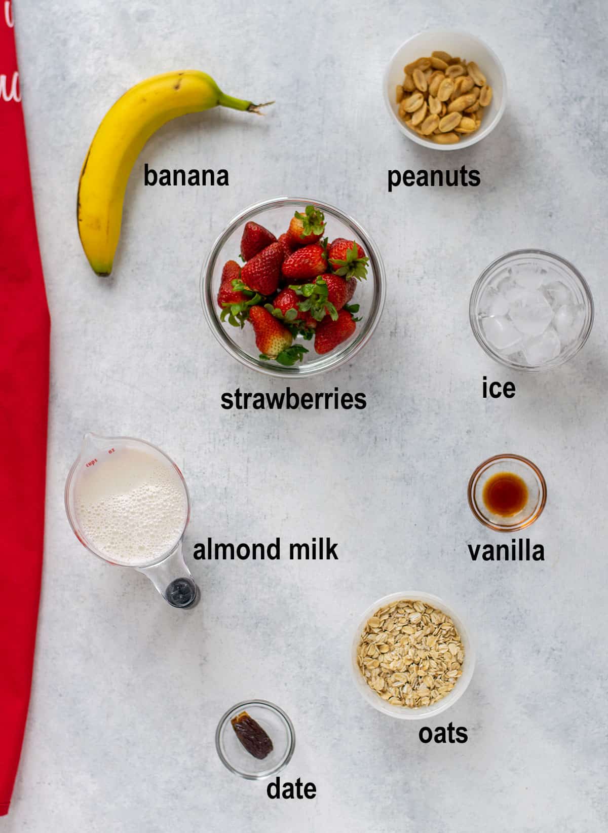banana, peanuts, strawberries, ice, almond milk, vanilla, date, oats.
