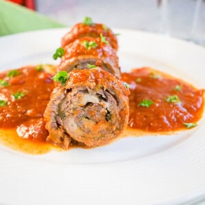 braciole roll on a plate with sauce