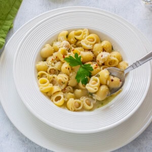 plate of pasta with chickpeas with spoonful and garnished with parsley