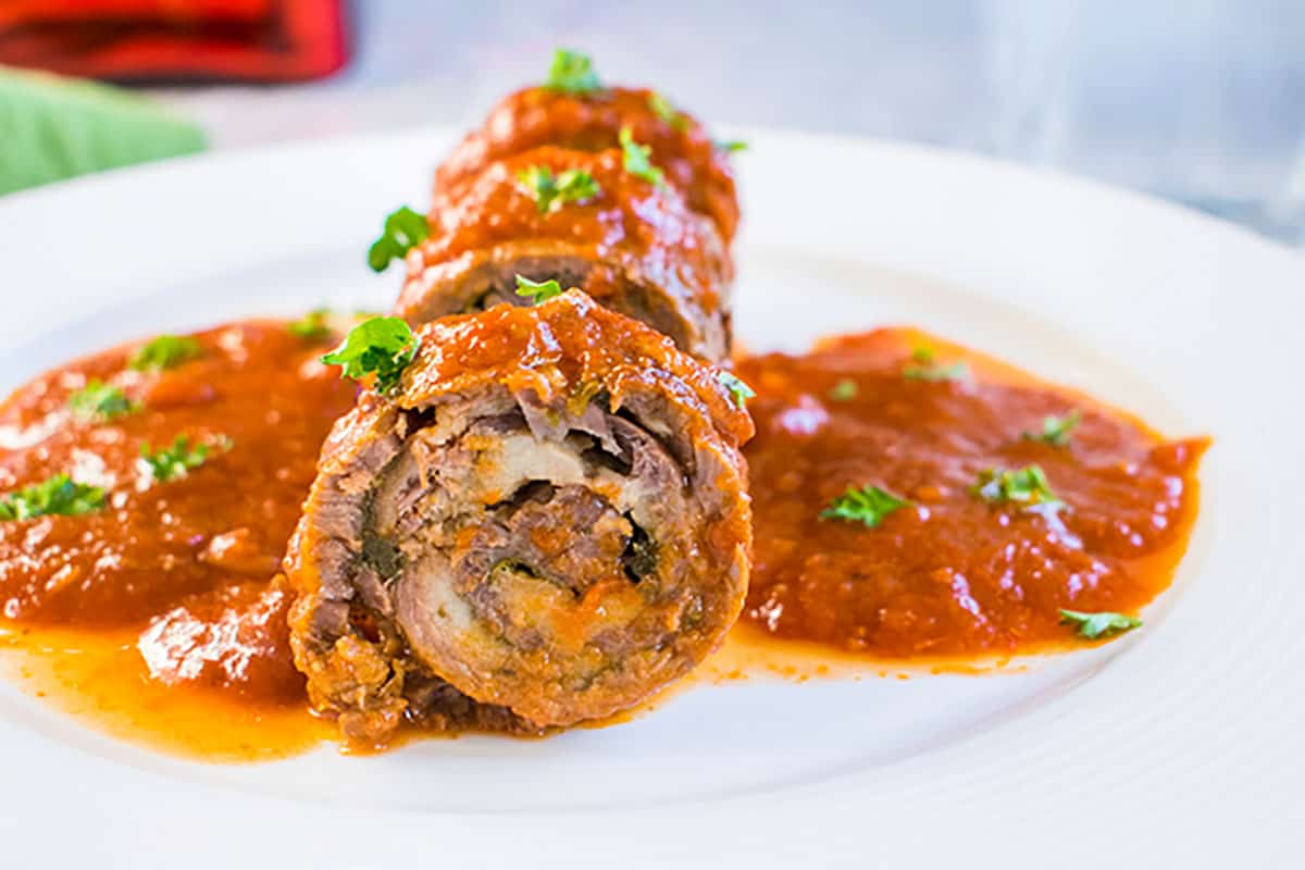 braciole roll on a plate with sauce