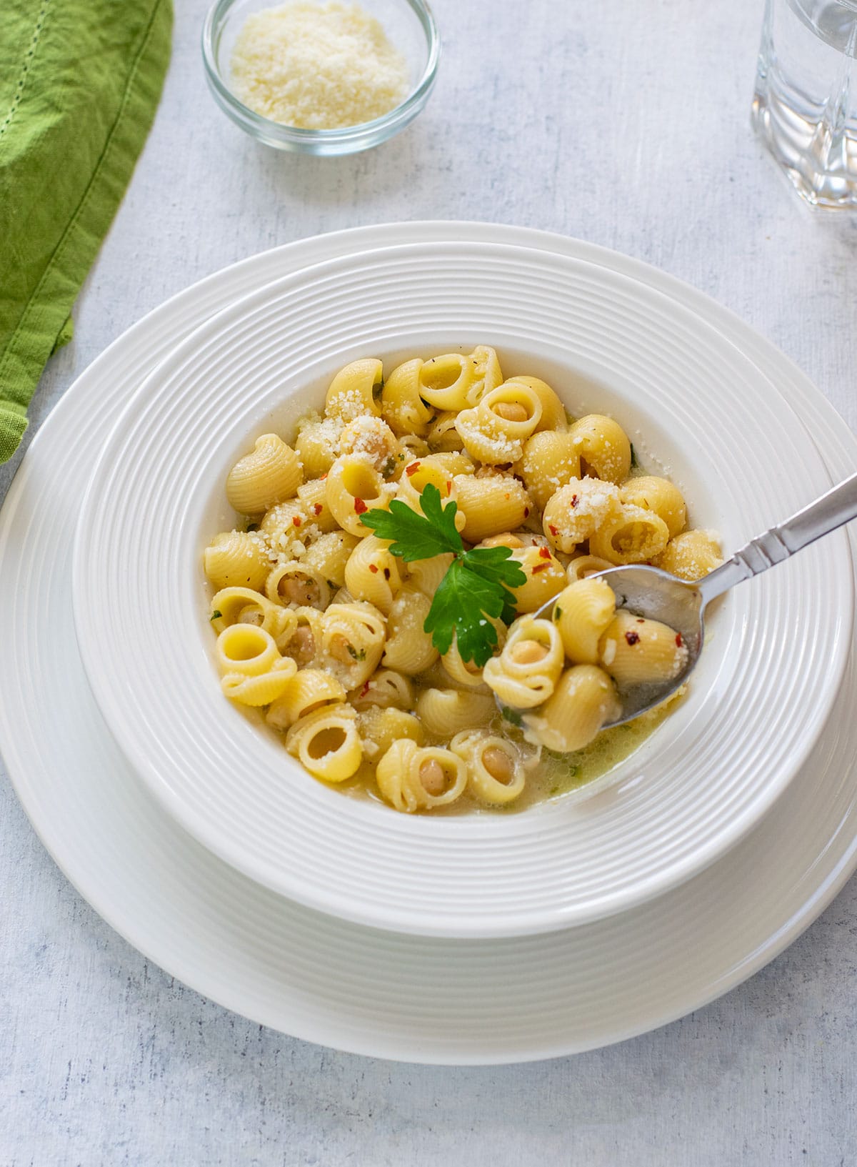 plate of pasta with chickpeas with spoonful and garnished with parsley