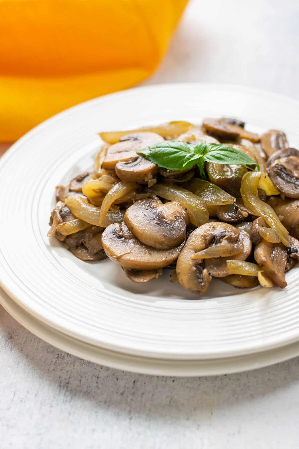 plate of sautéed mushrooms and onions garnished with basil