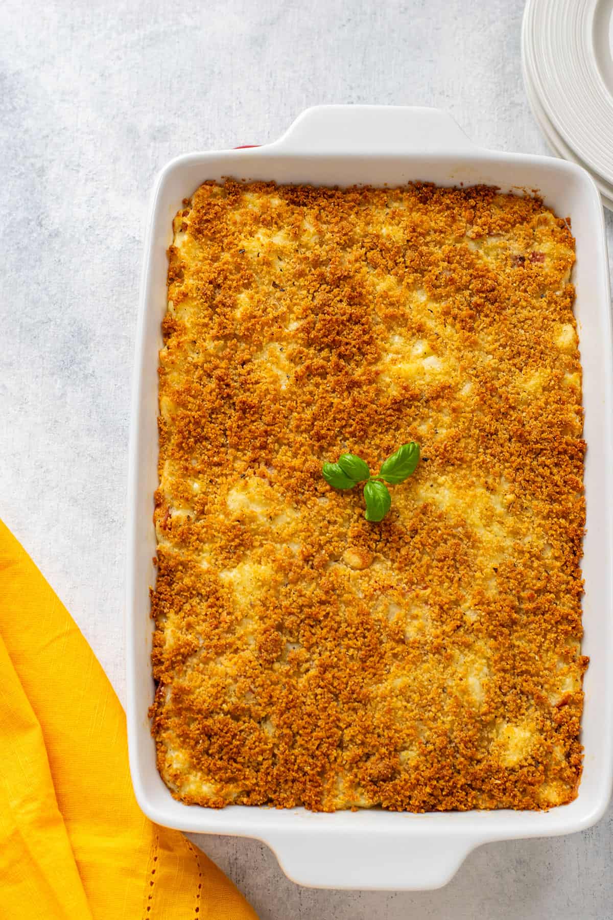 pan of gattò di patate (Italian potato casserole) topped with basil