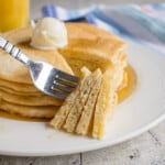 stack of homemade pancakes with butter and syrup
