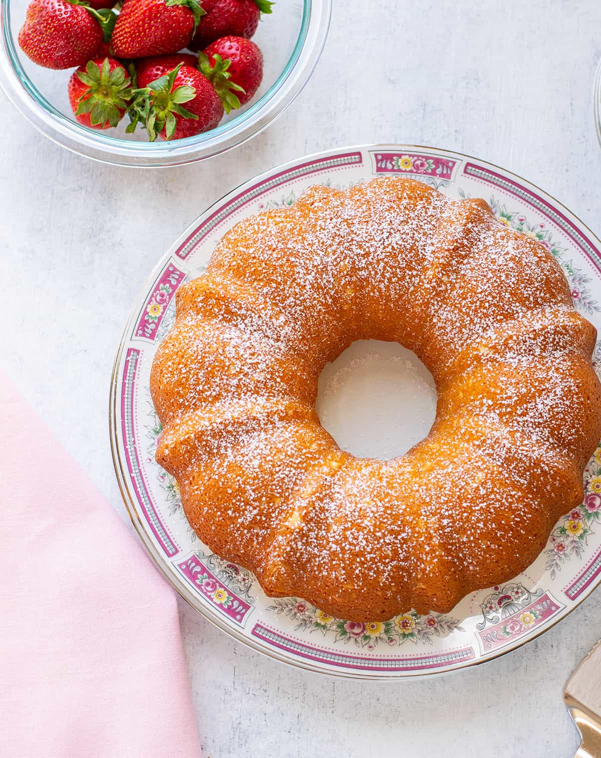italian bundt cake on a plate with strawberries