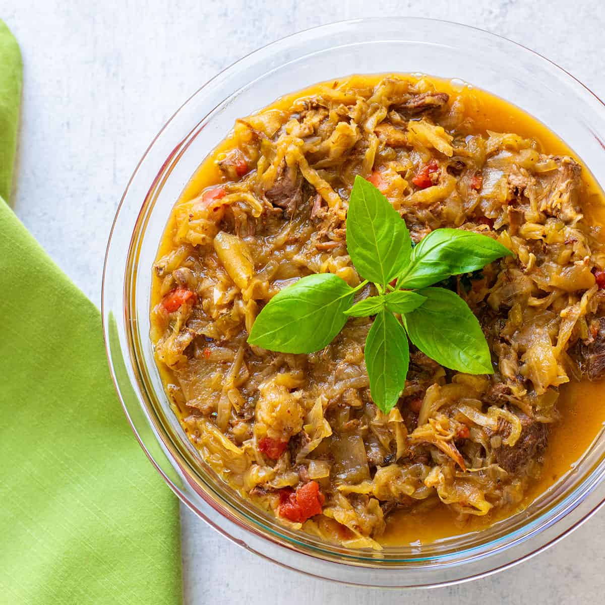 bowl of Genovese meat and onion sauce topped with basil