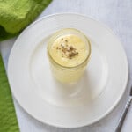 glass jar of homemade mayo garnished with basil flakes